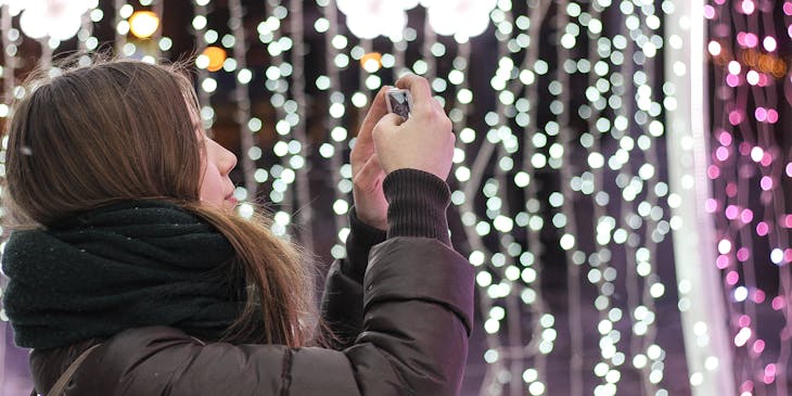Woman installing a Christmas light display.