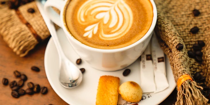 A beautifully presented frothy cup of coffee served at a coffee and tea business.