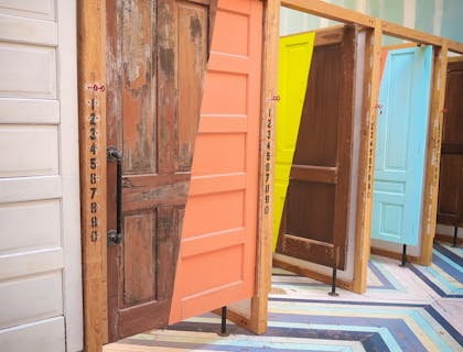 Interesting and colorful row of partially or fully painted wooden doors.