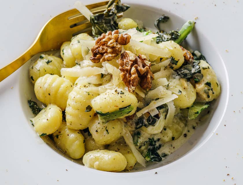 Gnocchi in a wide-rimmed pasta plate served in an Italian restaurant.