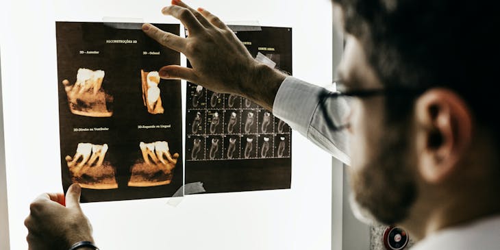 Orthodontist viewing scans of a patient's mouth.