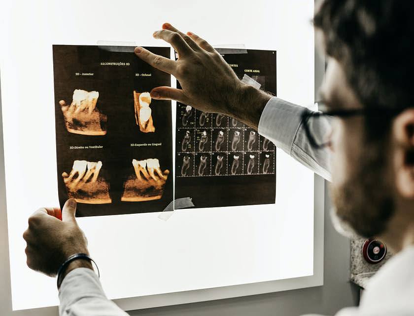 Orthodontist viewing scans of a patient's mouth.
