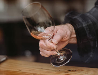 Un sommelier che fa areare del vino rosé prima della degustazione durante un corso per sommelier.