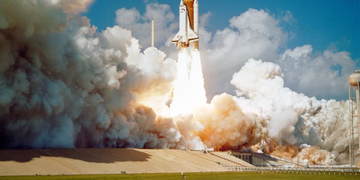 A space shuttle taking off from the launch pad.