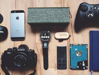 An assortment of gadgets laid out on a table.