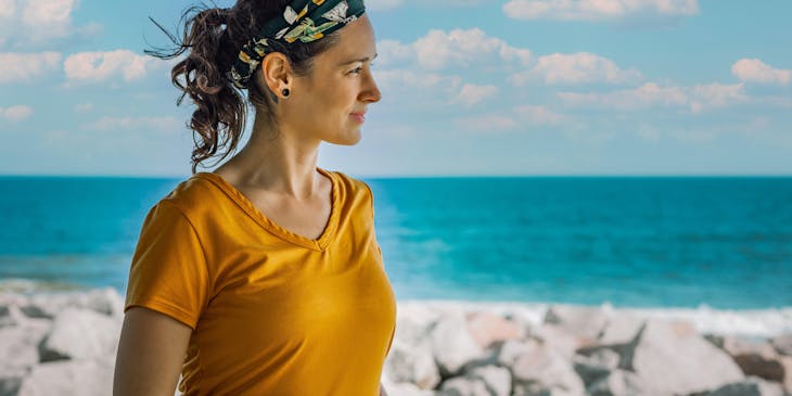 A woman wearing a headband on the beach.