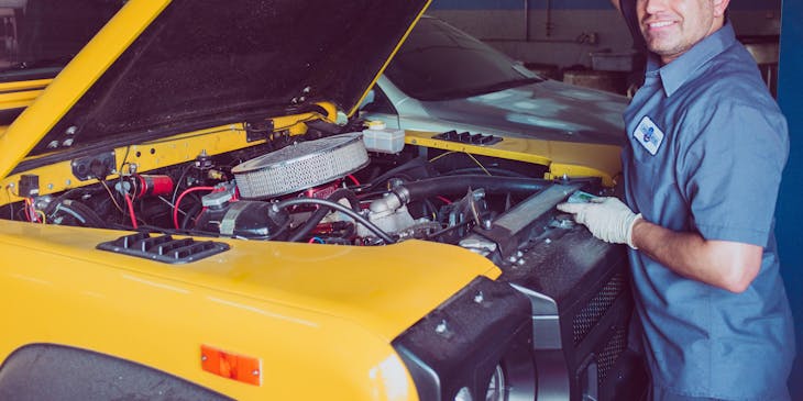 A mobile mechanic opening the hood of a automobile.