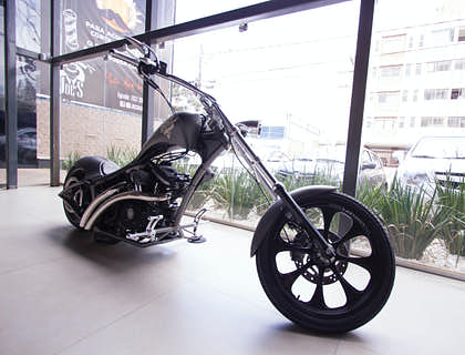 A chopper motorcycle on display in a motorcycle shop.