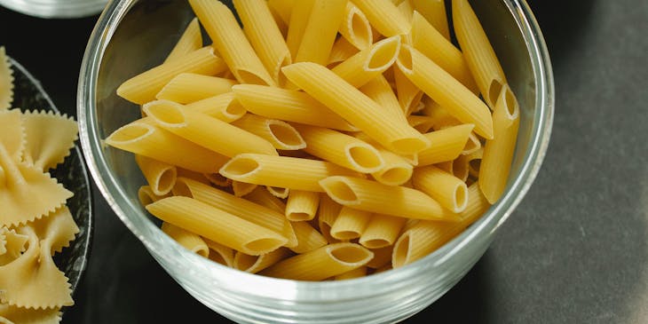 A set of bowls with various types of pasta.