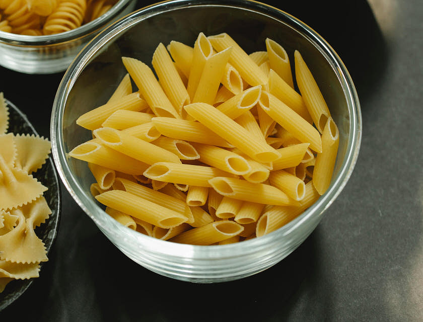 A set of bowls with various types of pasta.