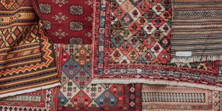 An assortment of rugs for cleaning.