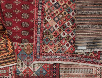 An assortment of rugs for cleaning.