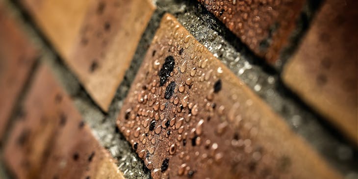 Water droplets on bricks that have been waterproofed.