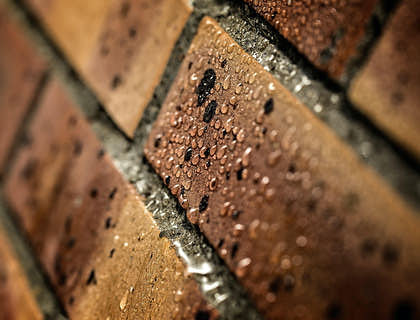 Water droplets on bricks that have been waterproofed.