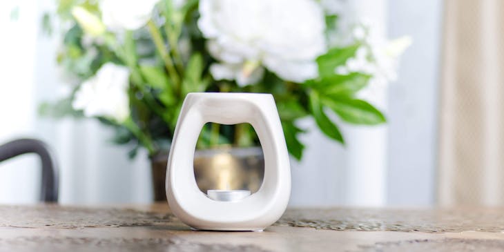 A wax melt burner on a table.