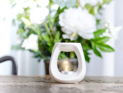 A wax melt burner on a table.