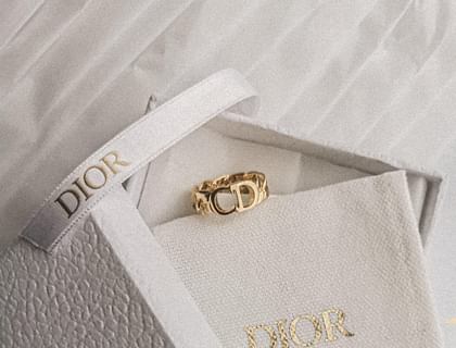 A white jewelry box with the 4-letter brand name "Dior" on it.