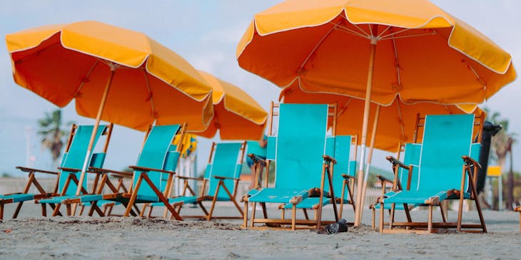 A collection of blue and orange beach rental equipment.