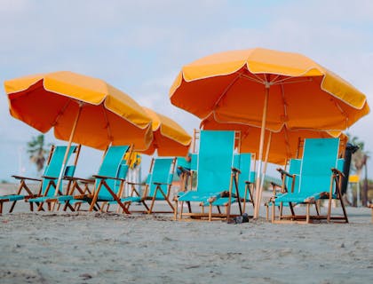 A collection of blue and orange beach rental equipment.