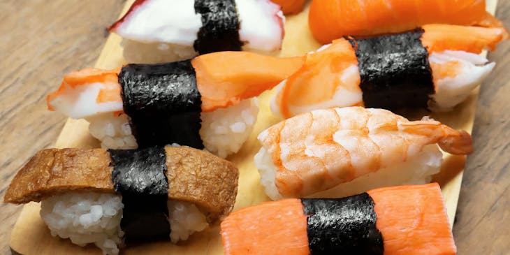 Sushi served on a wooden platter.