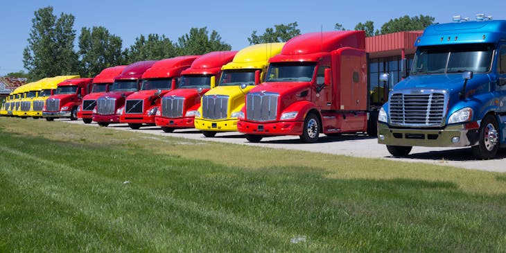 Colorful trucks parked diagonally in a row.