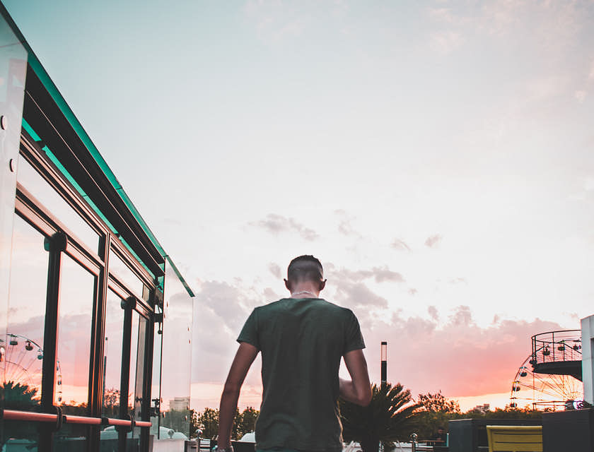Un homme avec sa sacoche en train de marcher sur une terrace.