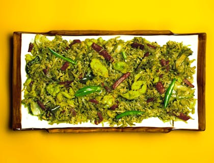 Un plat de riz et viande dans une assiette rectangulaire blanche.