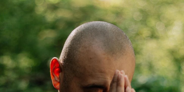 A spiritual coach demonstrating a prayer position.