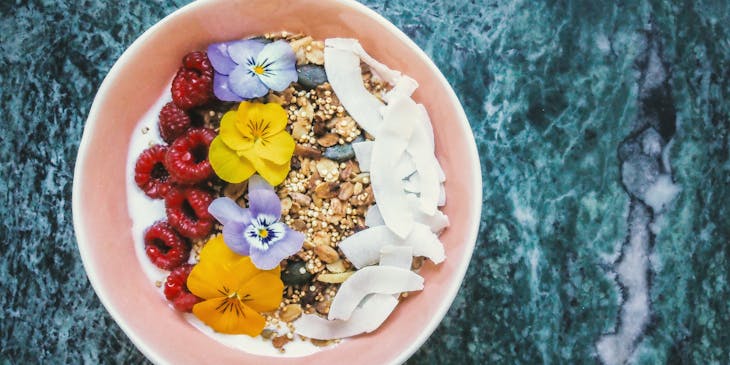 Aerial view of acai bowl on blue background.