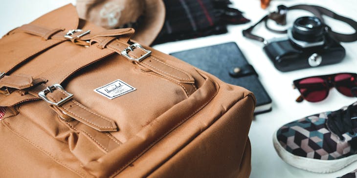 A leather bag, hat, scarf, and other ites for sale by an accessories business.
