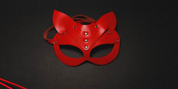 A mask and whip sold at an adult store on a black background.