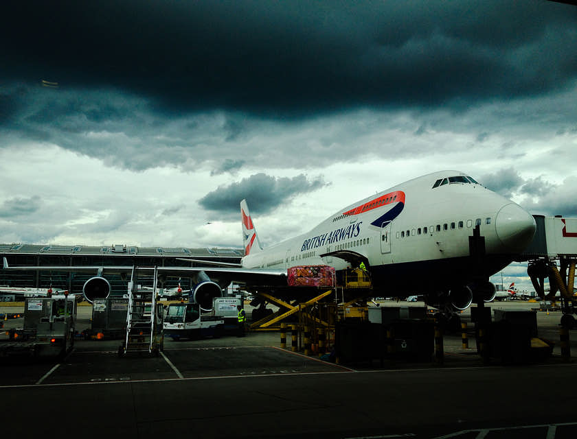 Plane parked on a runway outside an airline business.