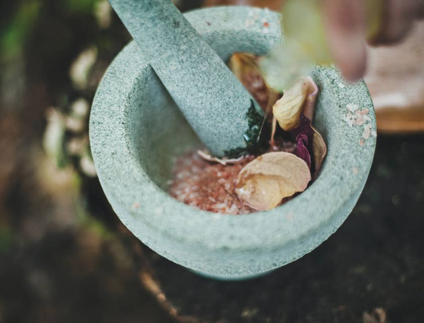 A mortar and pestle being used to make alternative medicine.