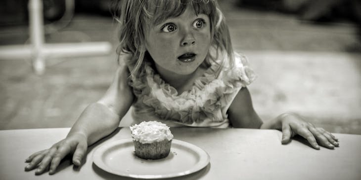 A little girl amazed at her surprise party.