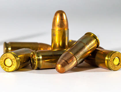 Gold bullets of an ammo on a white surface.