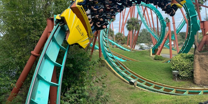 People riding the roller coaster at an amusement park.