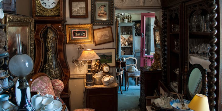 antique store with furniture, pictures, and glasswear