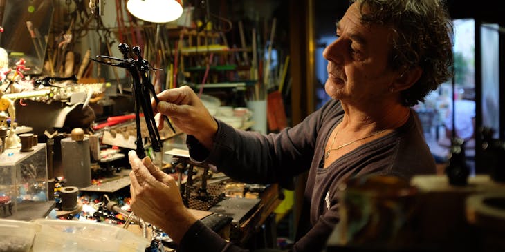 A man working in the studio of an antique restoration business.