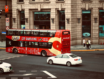 Red double-decker tour bus on an architectural tour.