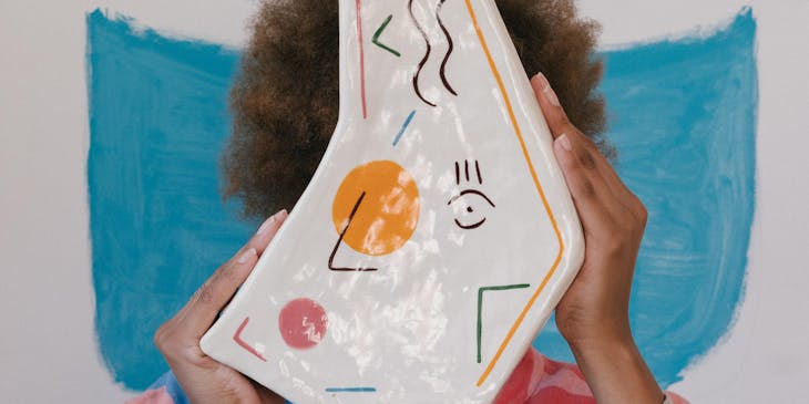 An artisan holding up one of their products.