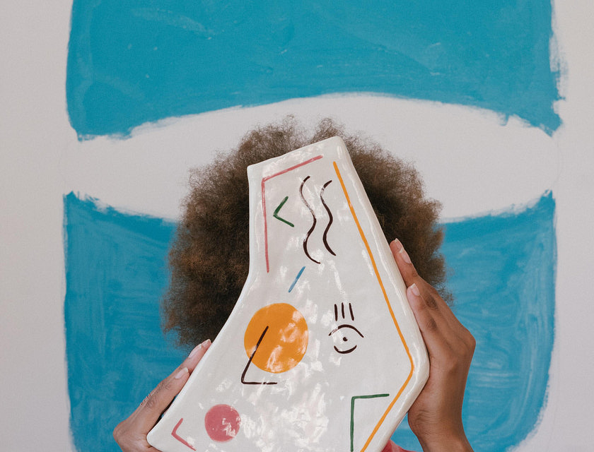 An artisan holding up one of their products.