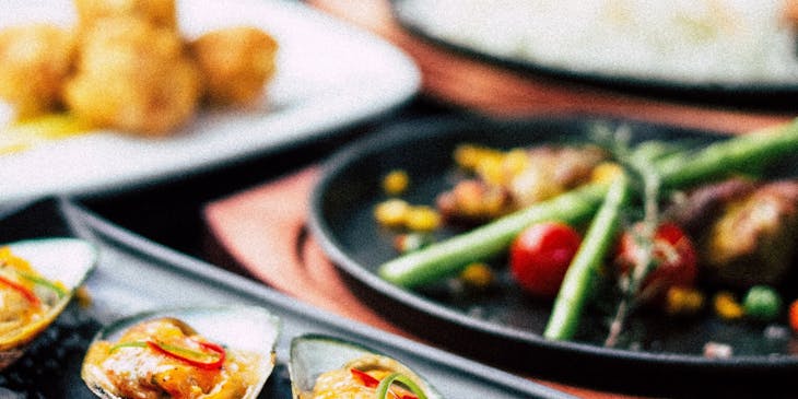 Multiple Asian dishes on a table at an Asian fusion restaurant.