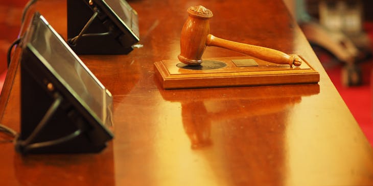 A wooden gavel on a table at an auction house.