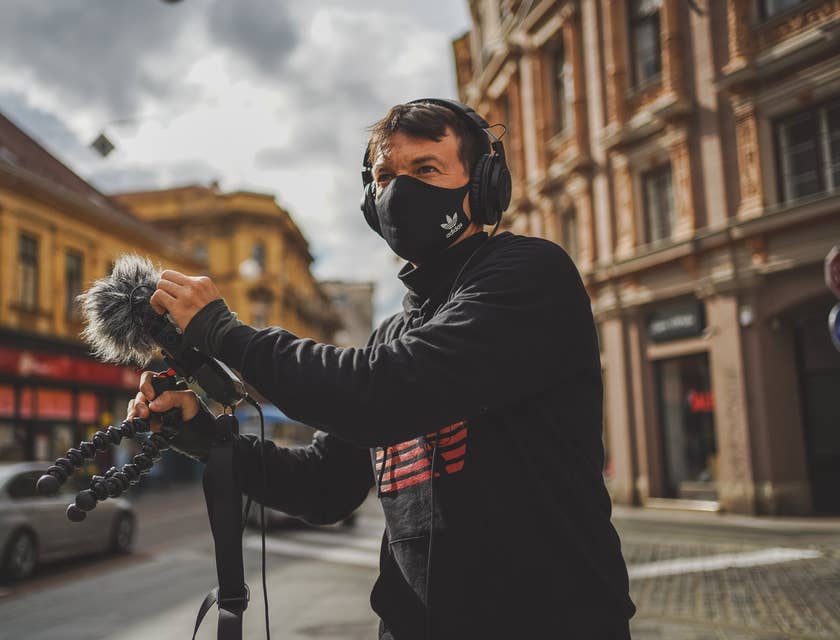 Person testing new audio equipment in the street outside an audio business.