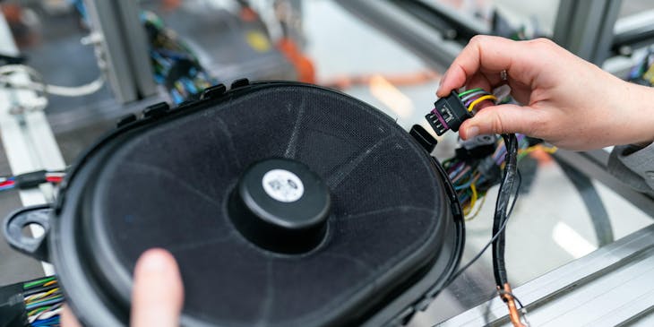 A technician working on audio installation.