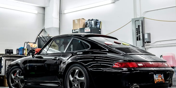 A black car in an auto detailing shop.