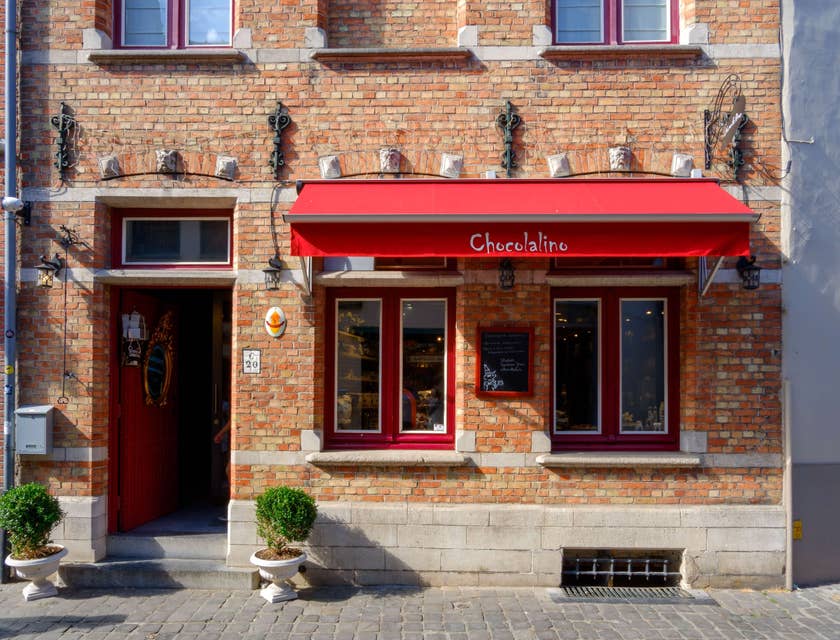 A red awning with Chocolalino label over a store window.
