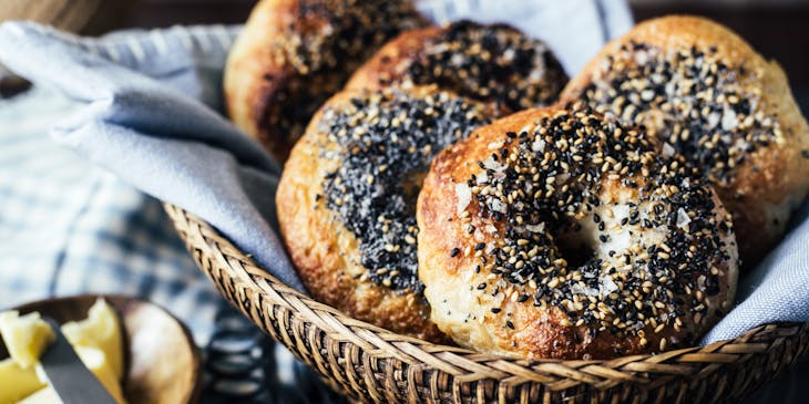 Bagels in a basket at a bagel shop.