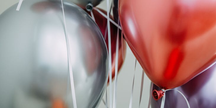 Colorful helium balloons with strings.