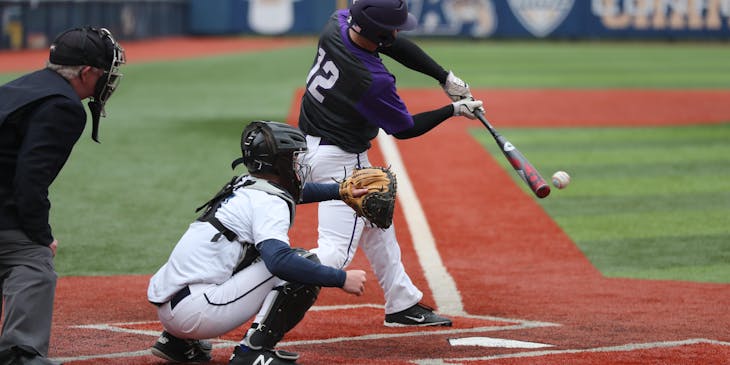 Sportsmen playing a game of baseball.